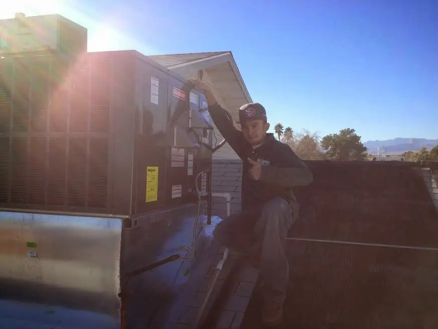 HVAC technician performing HVAC Inspection on a rooftop unit in Darnestown